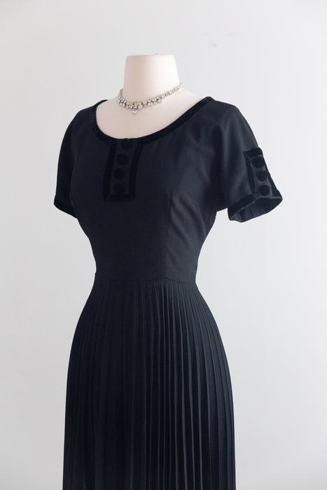 Elegant Early 1950's New Look Era Black Cocktail Dress With Pleated Skirt And Velvet Trim / M