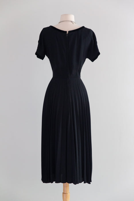 Elegant Early 1950's New Look Era Black Cocktail Dress With Pleated Skirt And Velvet Trim / M